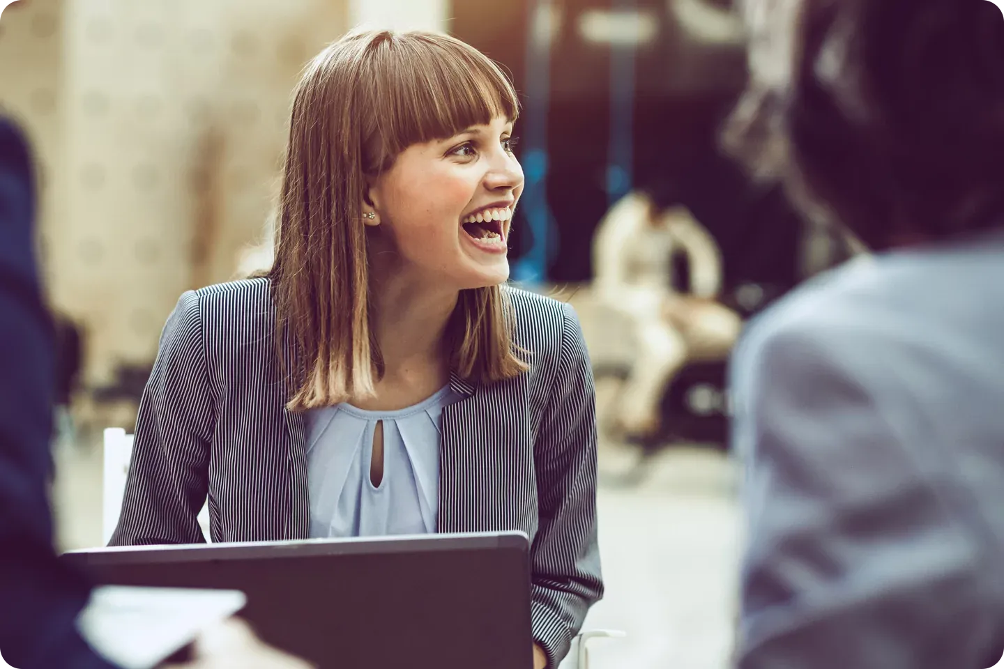 woman laughing with co-workers.