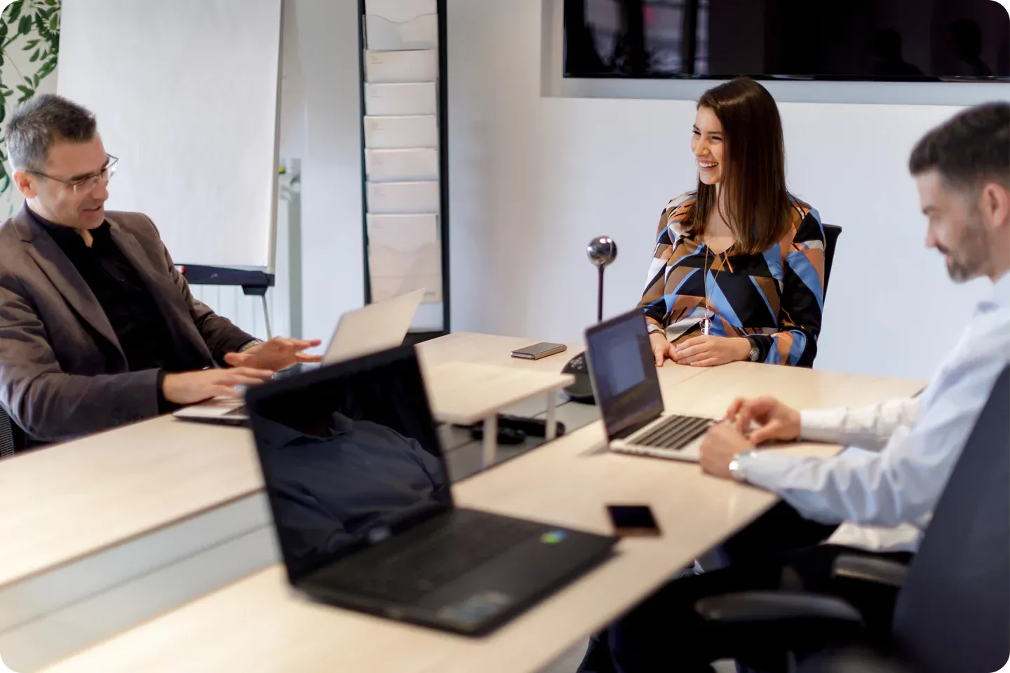 Couple of employees doing hard work in a conference room.