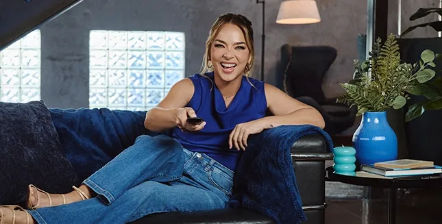 Adamari Lopez on couch watching DIRECTV