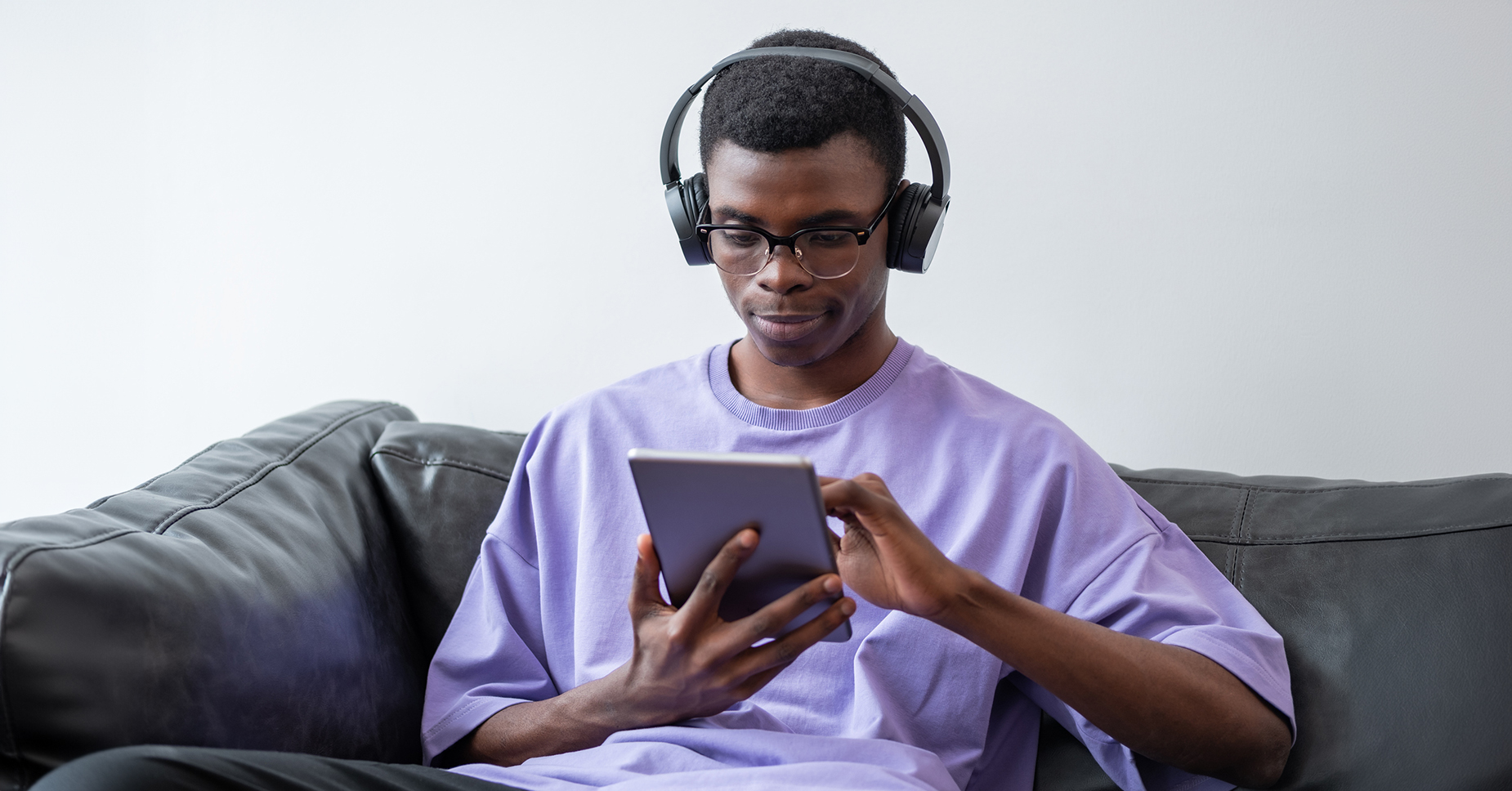 Man uses tablet at home with fast fiber internet.