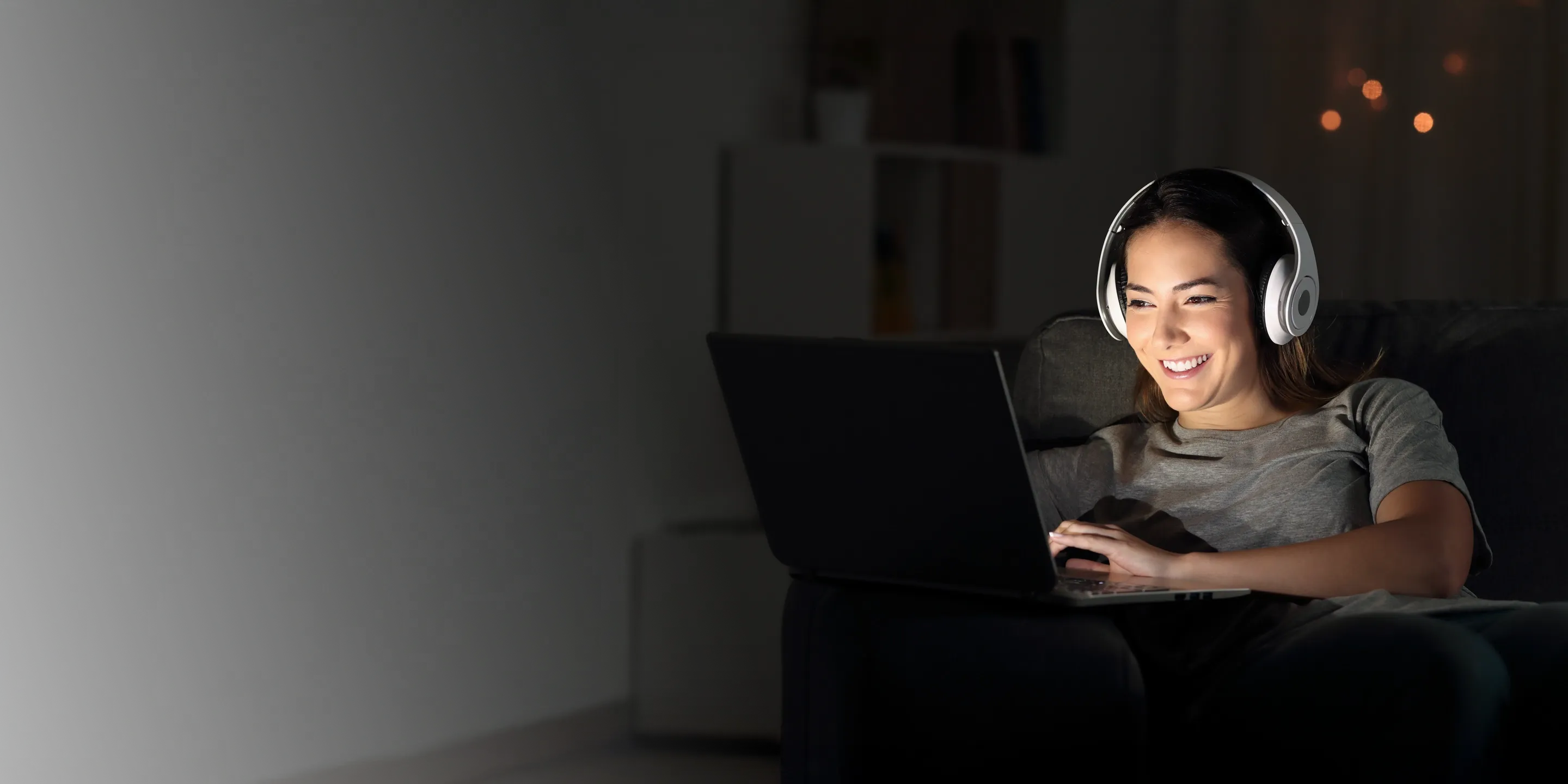 Girl cruising the web and streaming music and shows on her laptop.