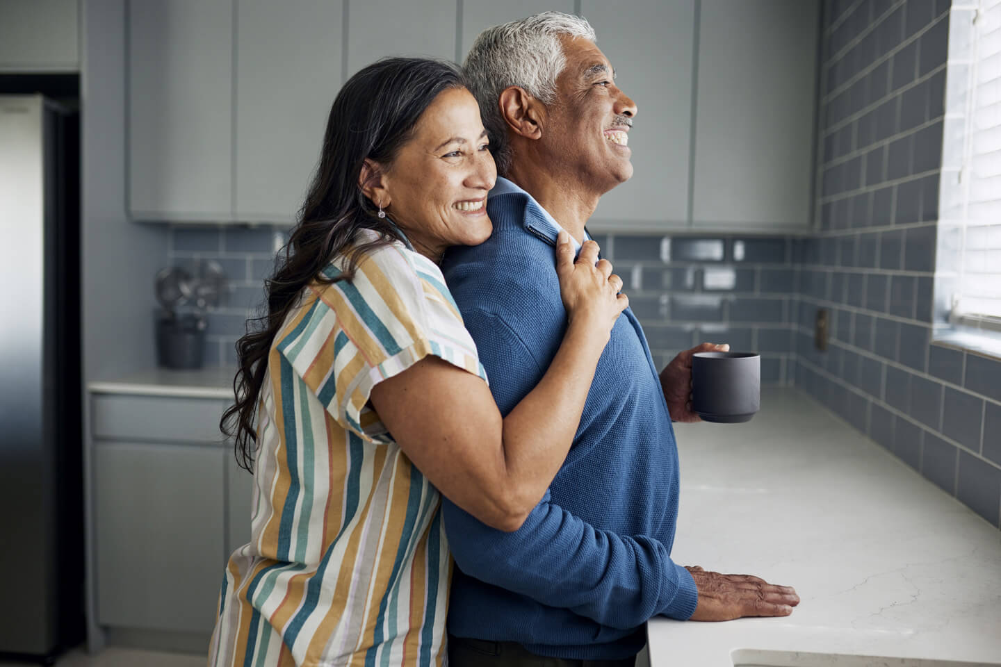 Couple embracing and looking out the window