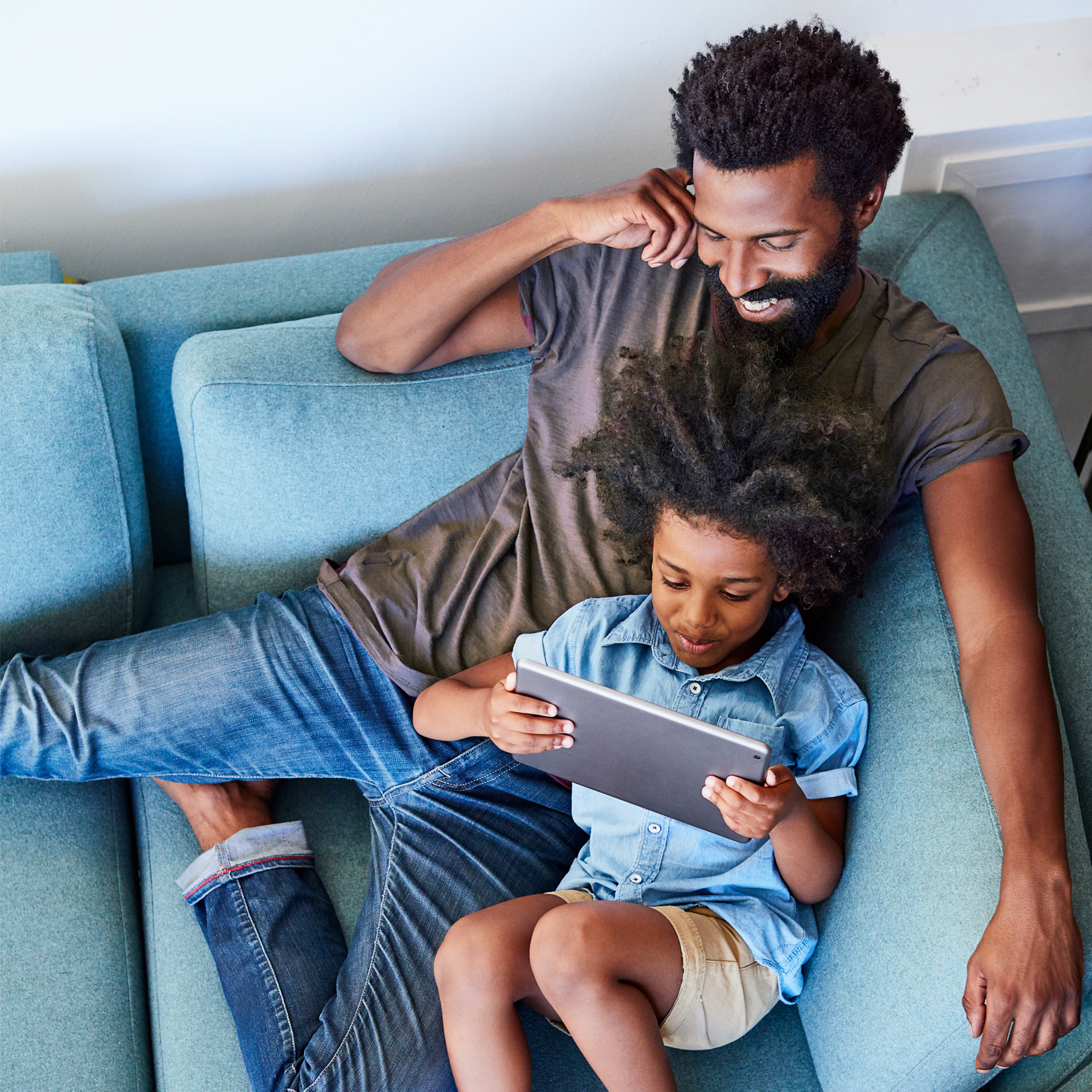 Father and Son enjoying content on a tablet