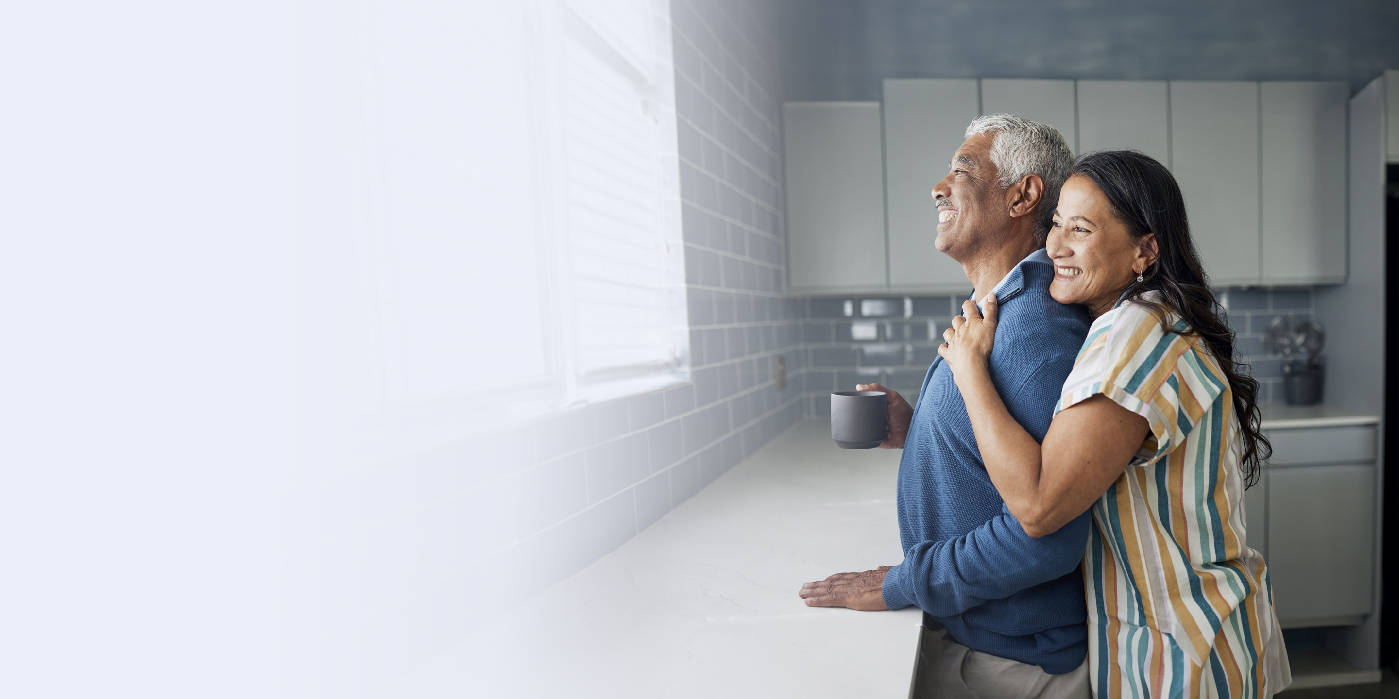 Couple embracing and looking out the window