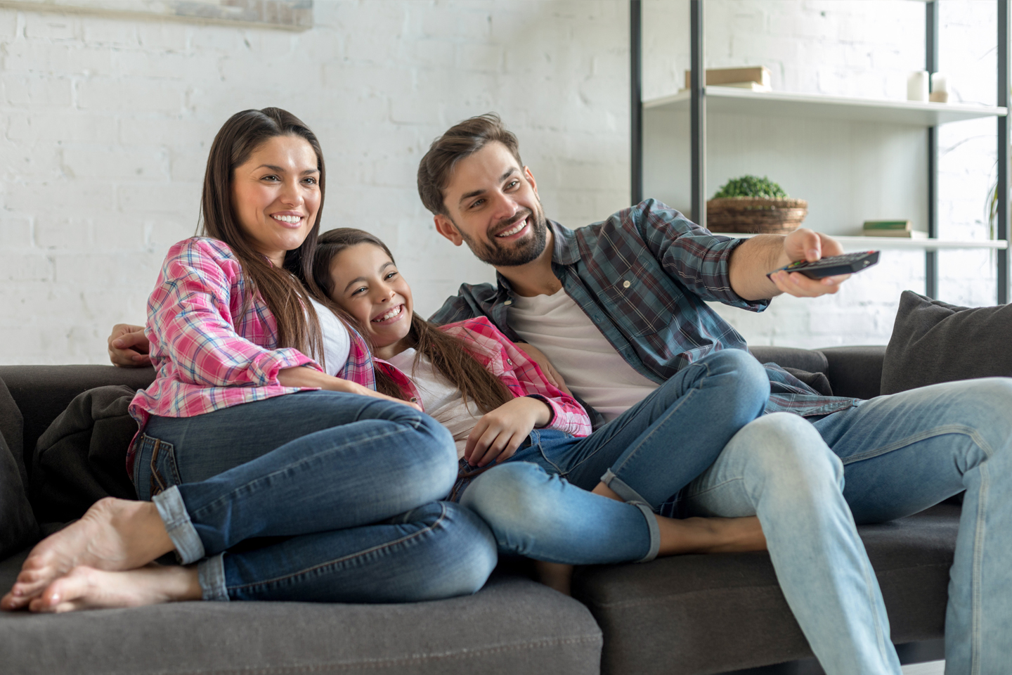 Family enjoying a TV show together on the Sofa