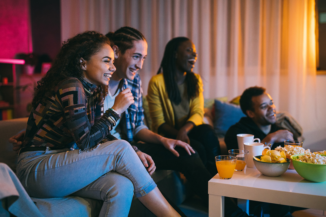Happy group of people watching tv together.