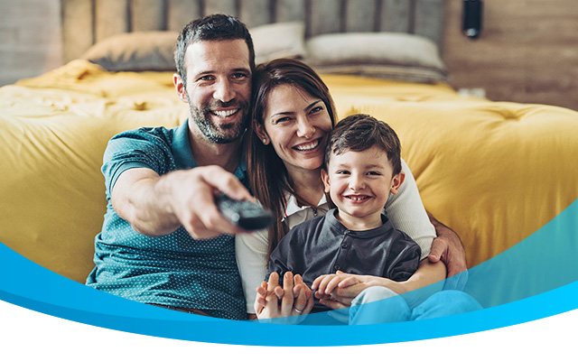 Happy family watches tv together.