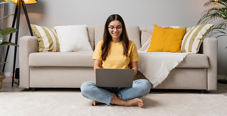 Happy woman tests her internet speed at home.