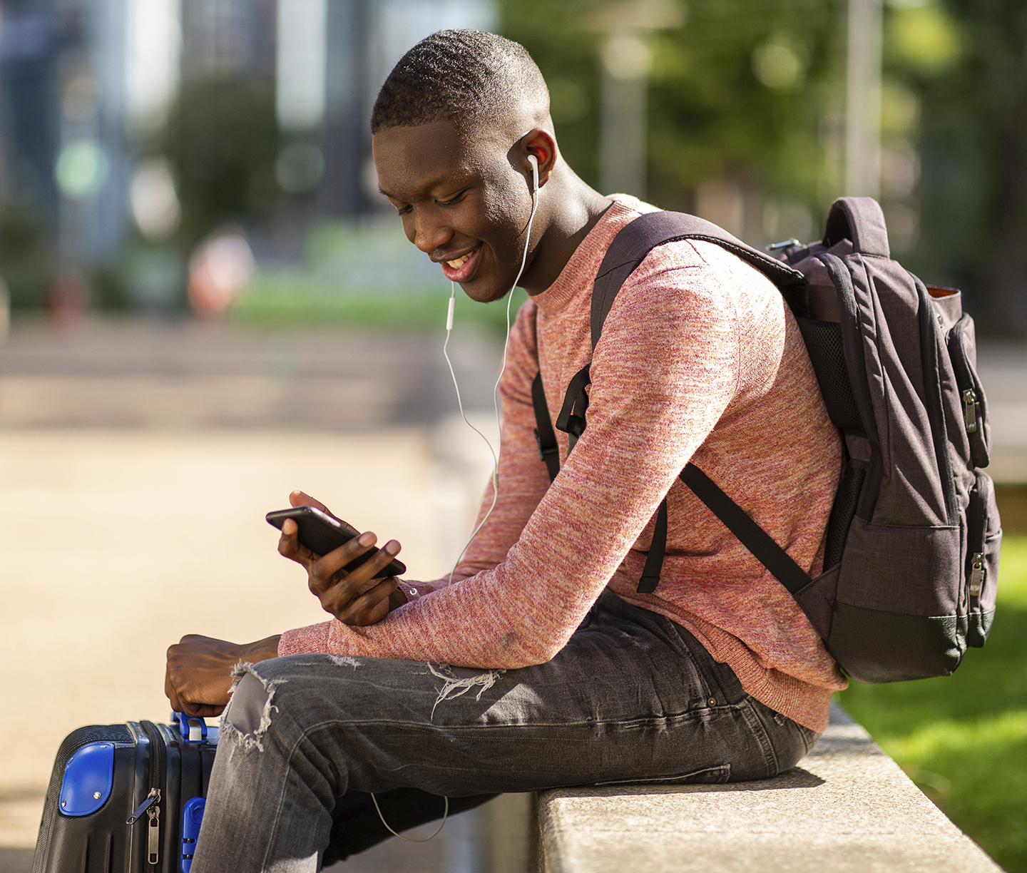 Man watching on phone outside a park