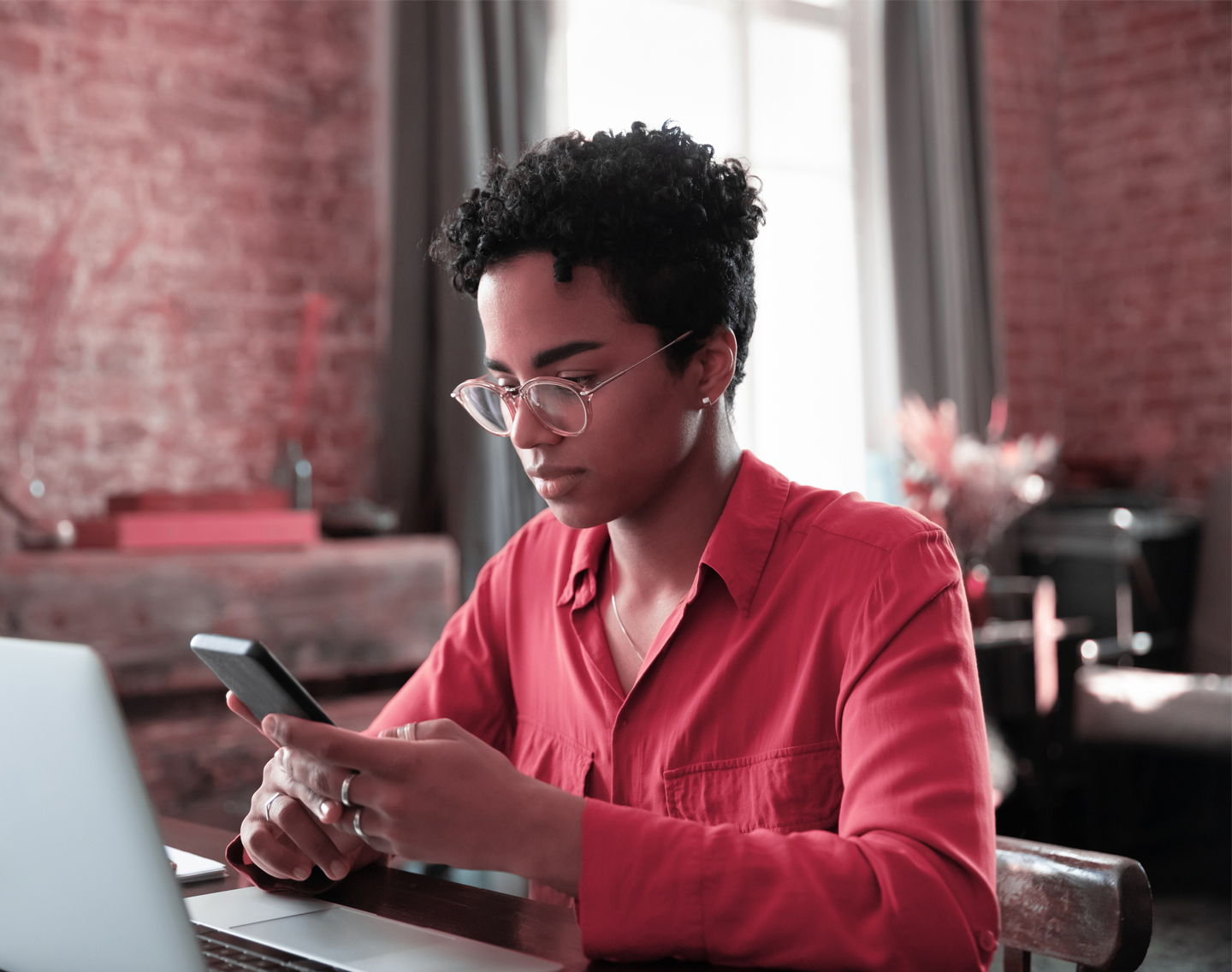 Woman wearing glasses and using an application on her phone