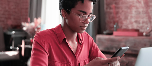 Woman wearing glasses and using an application on her phone