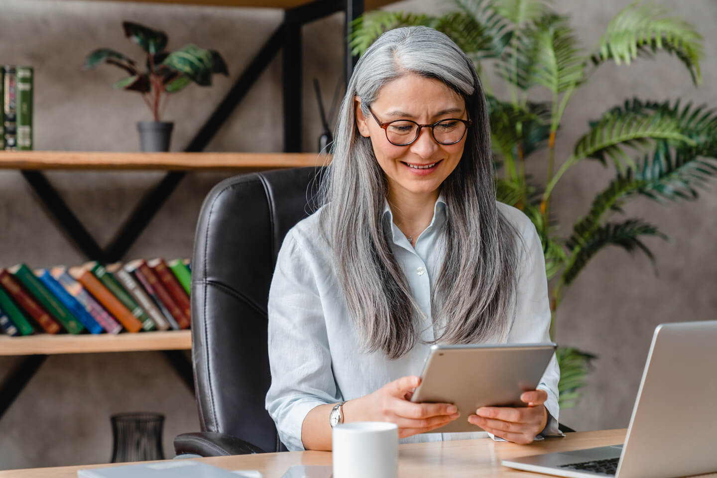 Silver Haired woman using tablet