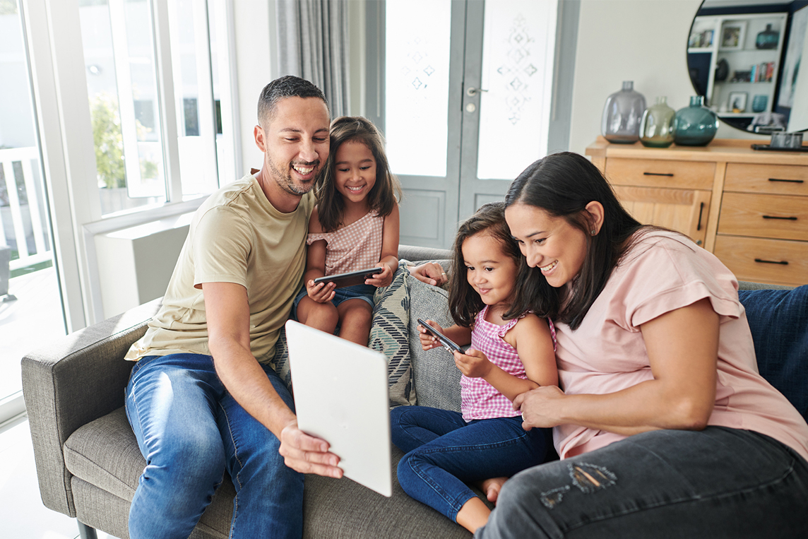 Young family using digital devices