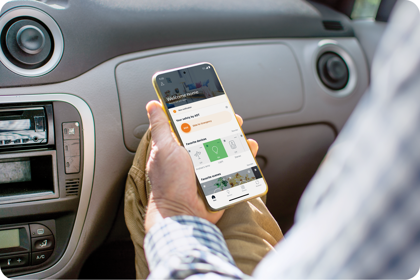 man controlling his smart lightbulbs with the ADT app