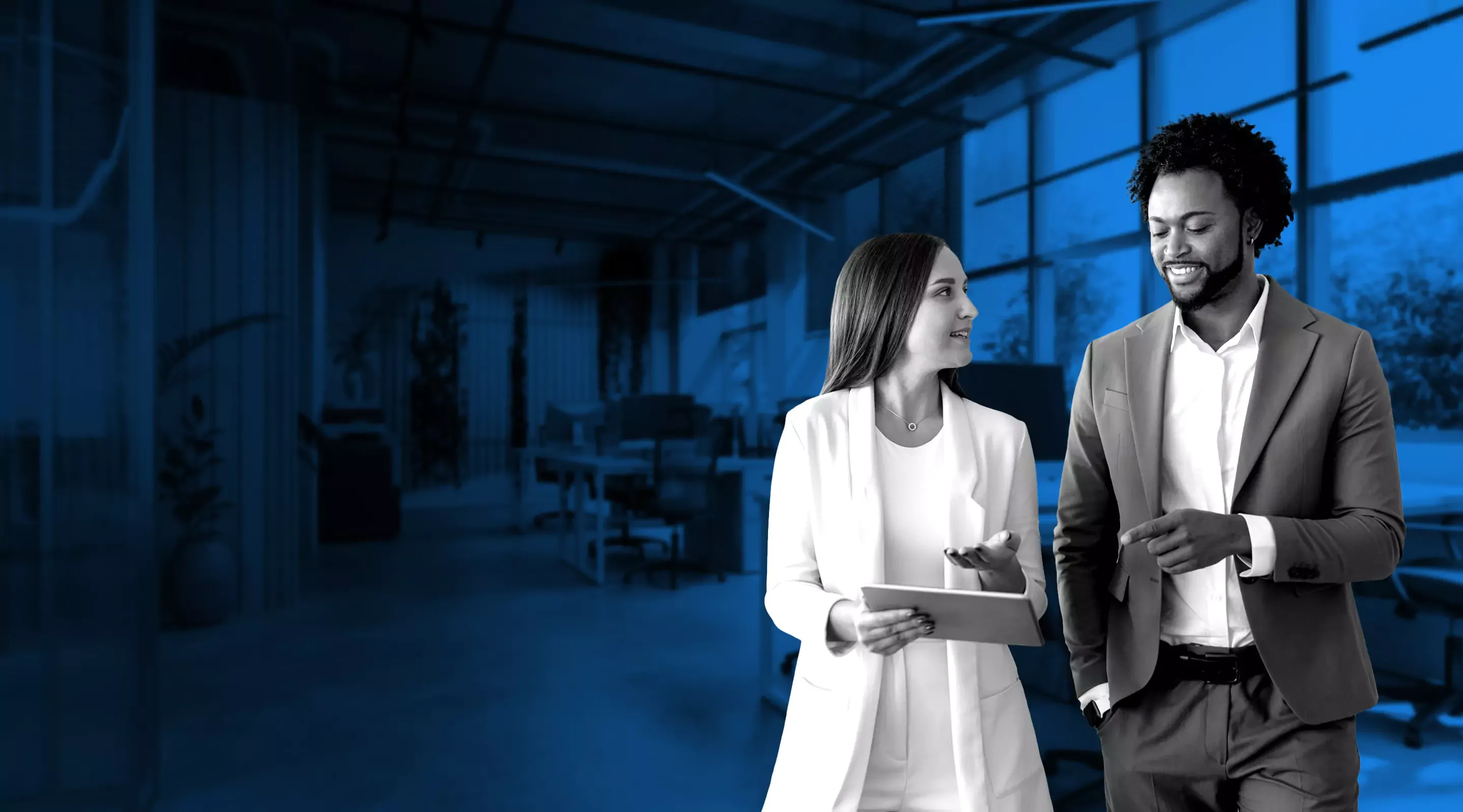 Two people walking and talking about work.