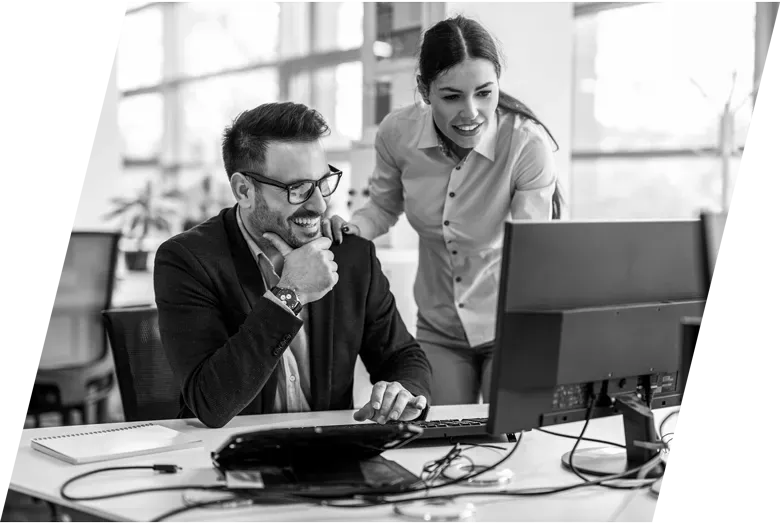 man and woman looking at a computer screen together