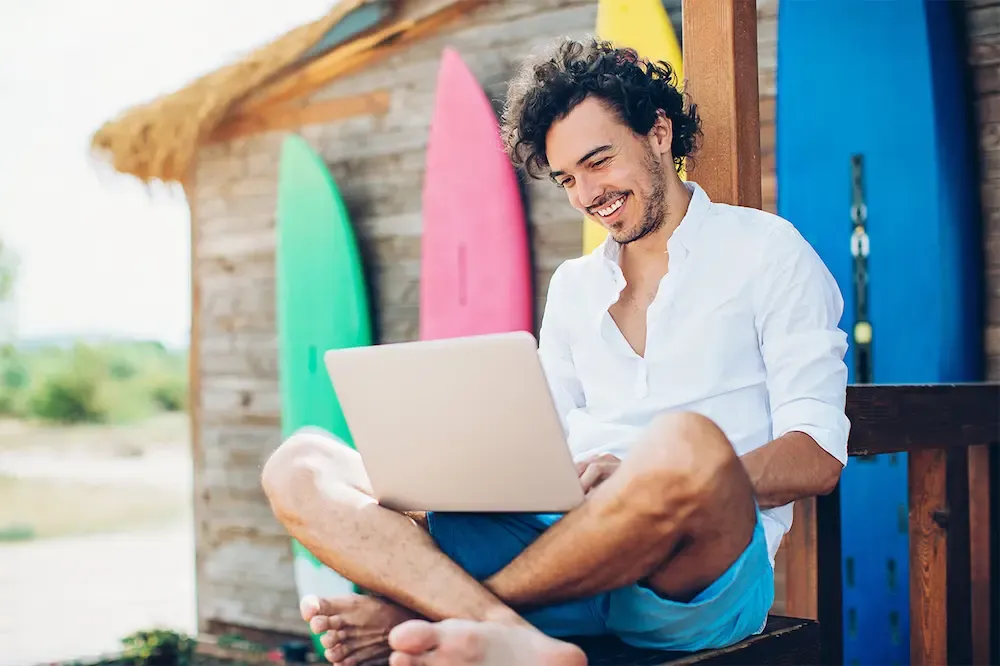 Man using laptop at remote island residence