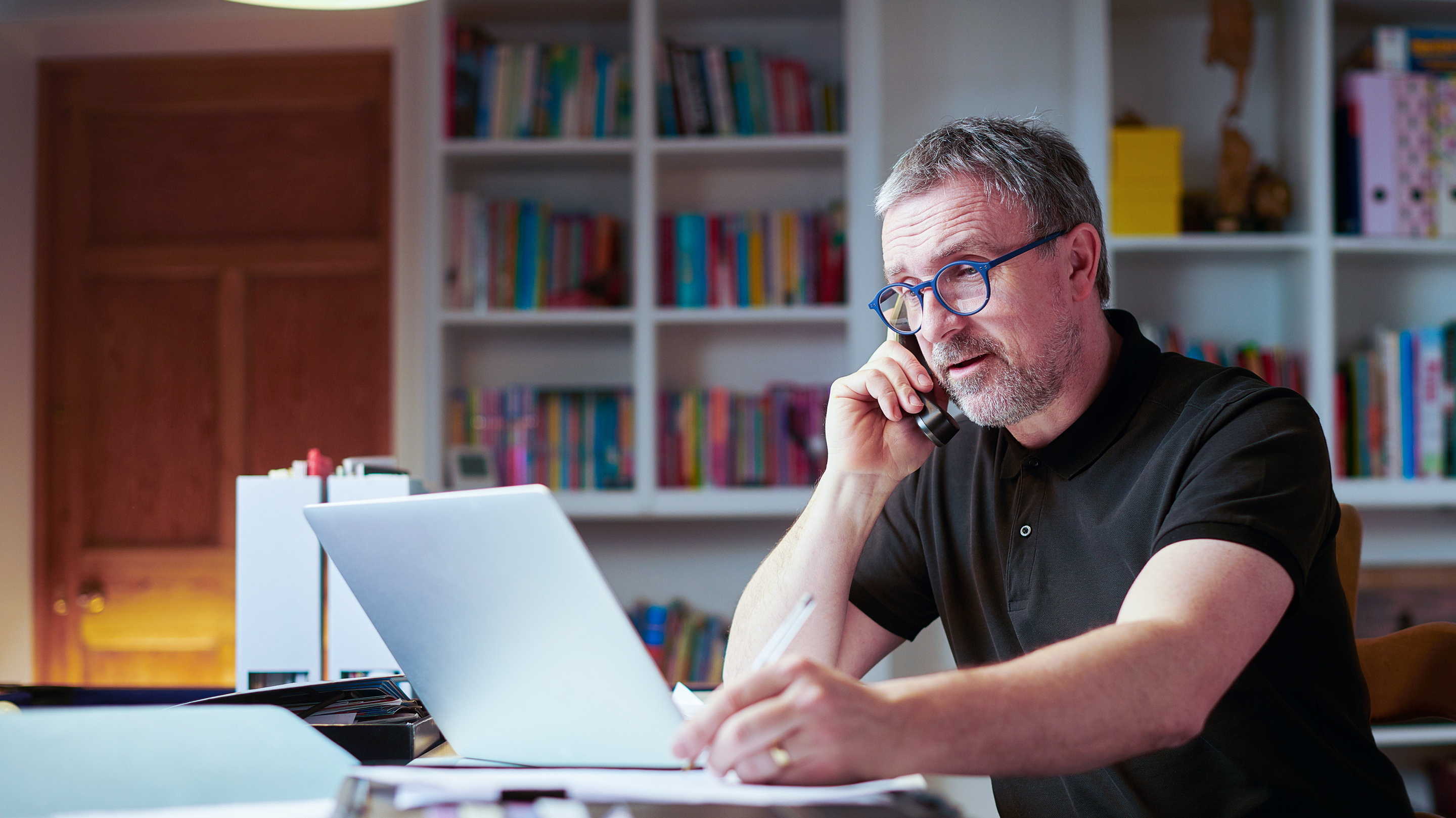 A man using CenturyLink internet to pay bills and work on the family budget