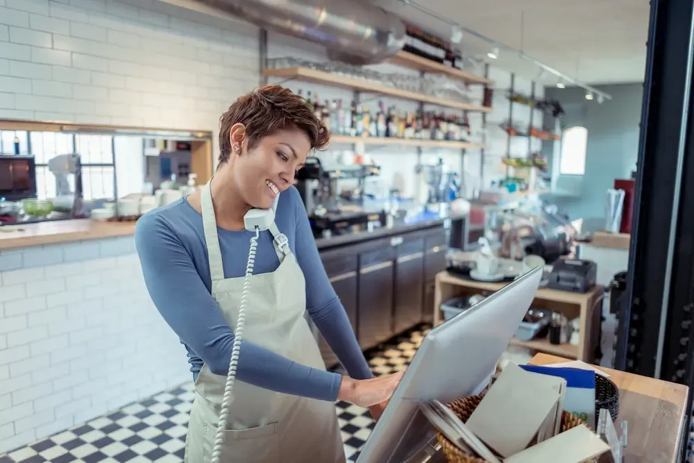 Restaurant worker taking phone order