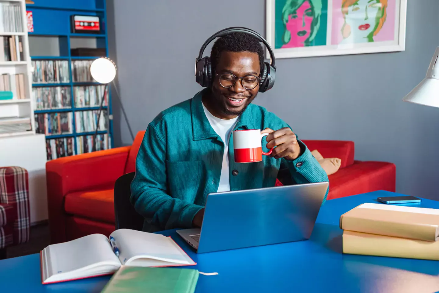 Man in colorful home working on his laptop.