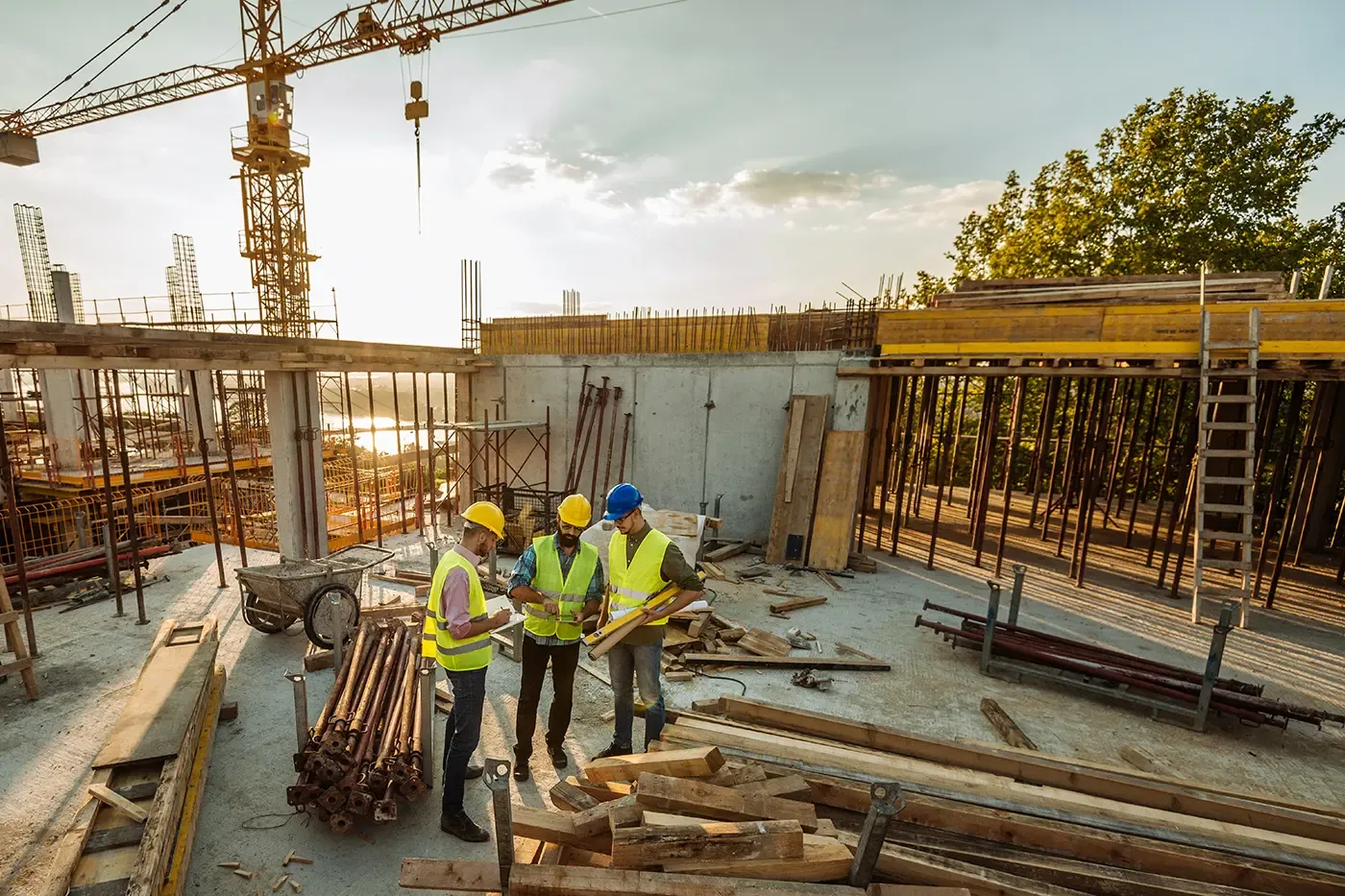 consruction workers looking at blueprint at job site