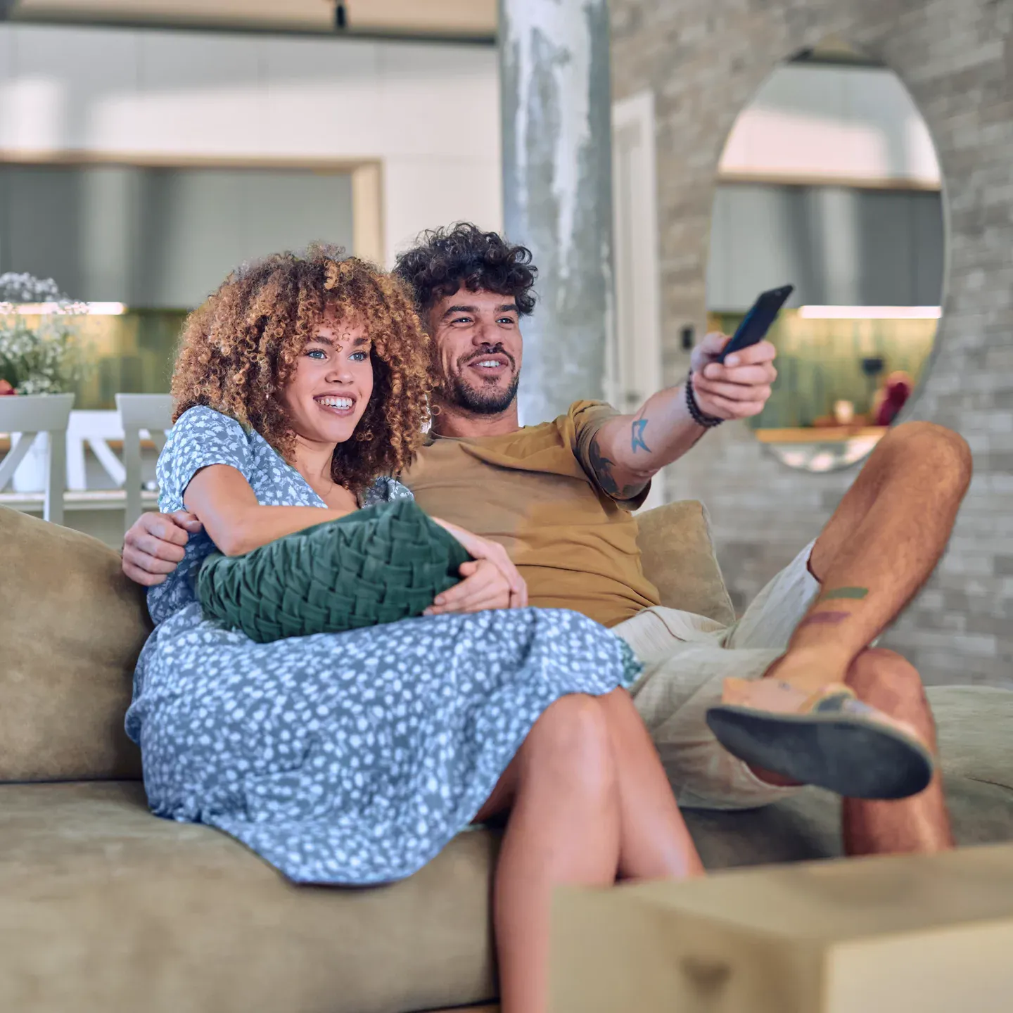 Young couple streaming their favorite show on the tv.