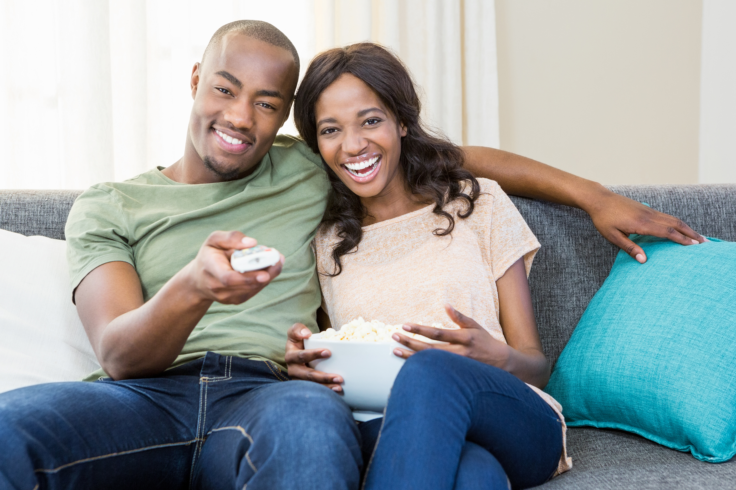 couple watching tv eating popcorn