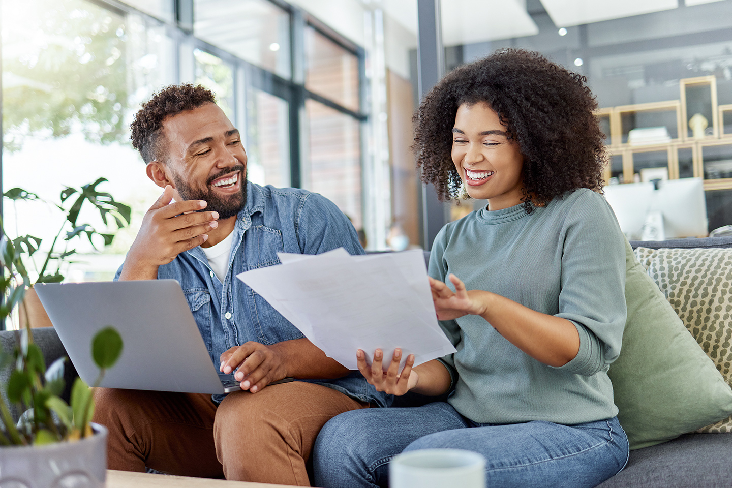 couple smiling, reviewing their internet bill
