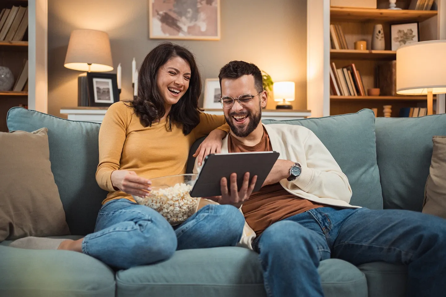 couple watching show on digital tablet