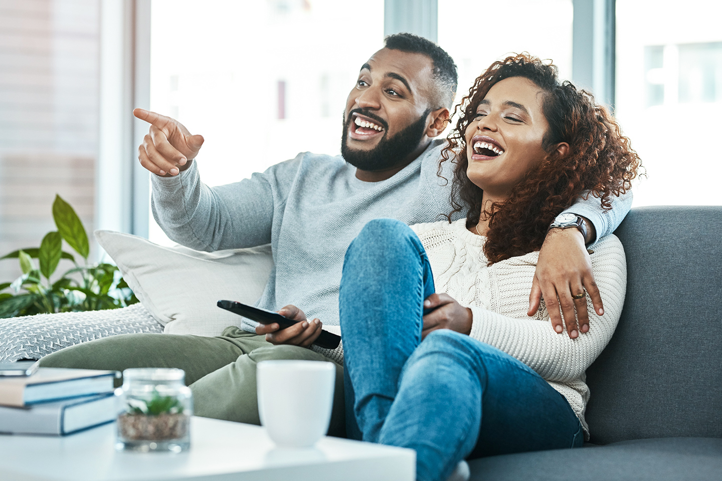 young couple watching television together at home