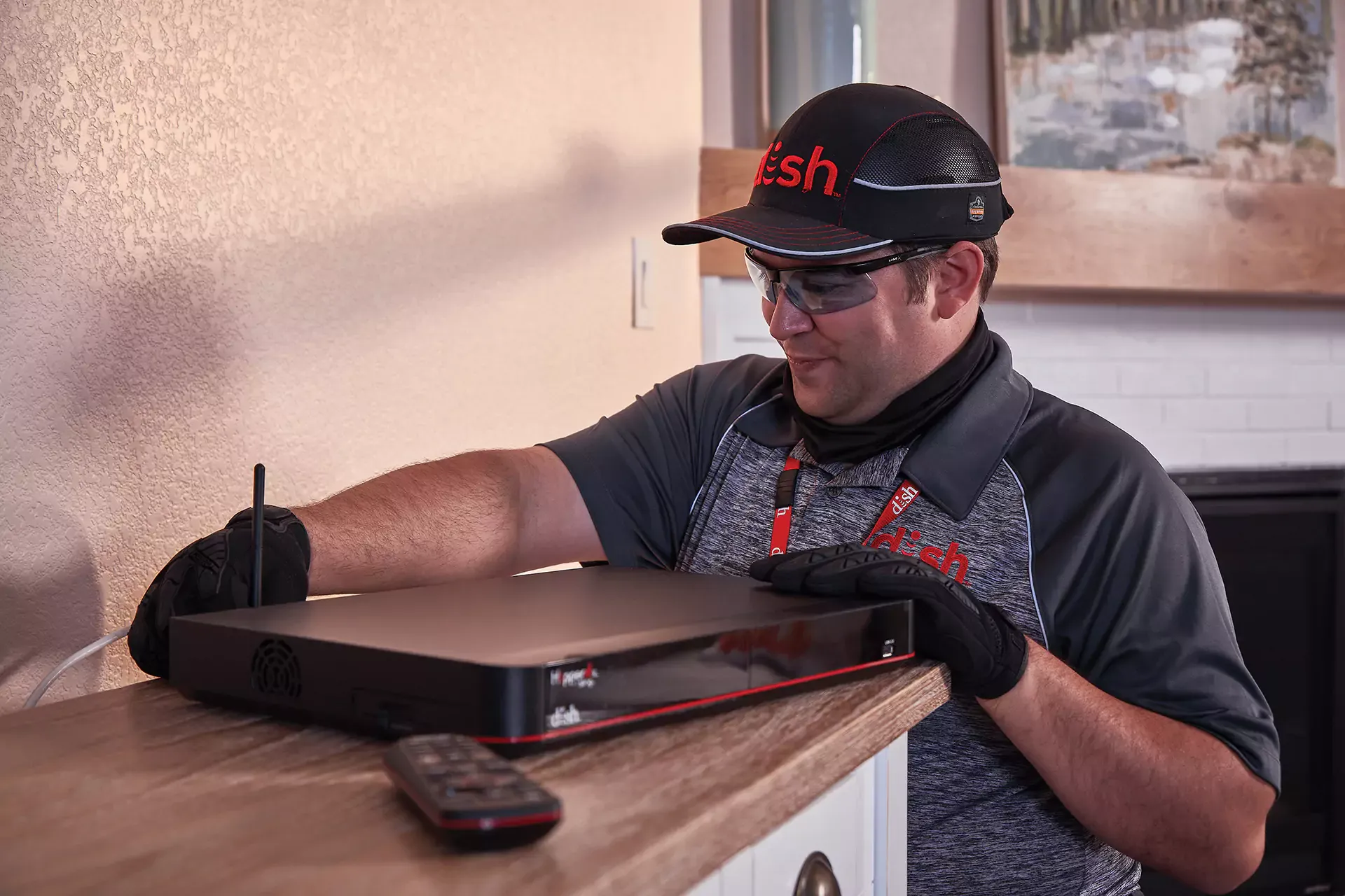 Dish technician installing services in home