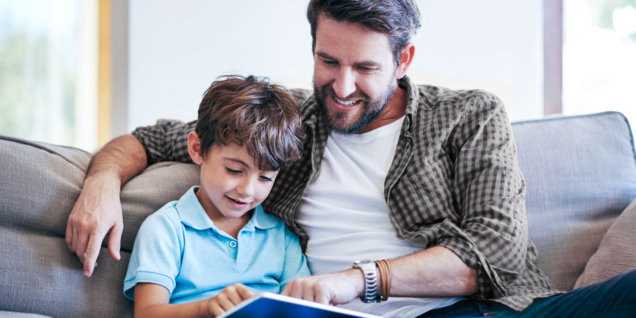 father and son on couch using CenturyLink internet