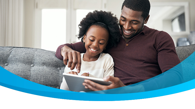 dad and daughter watching videos on ipad