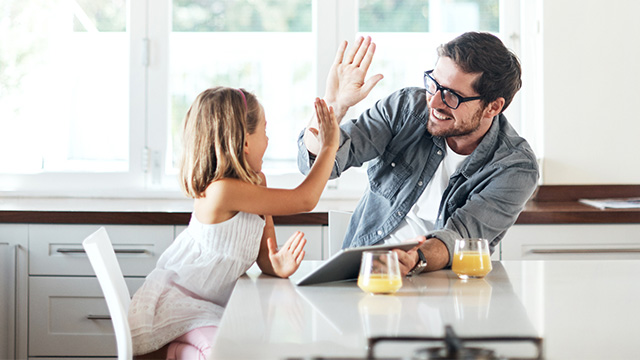 Dad giving daughter a high-five
