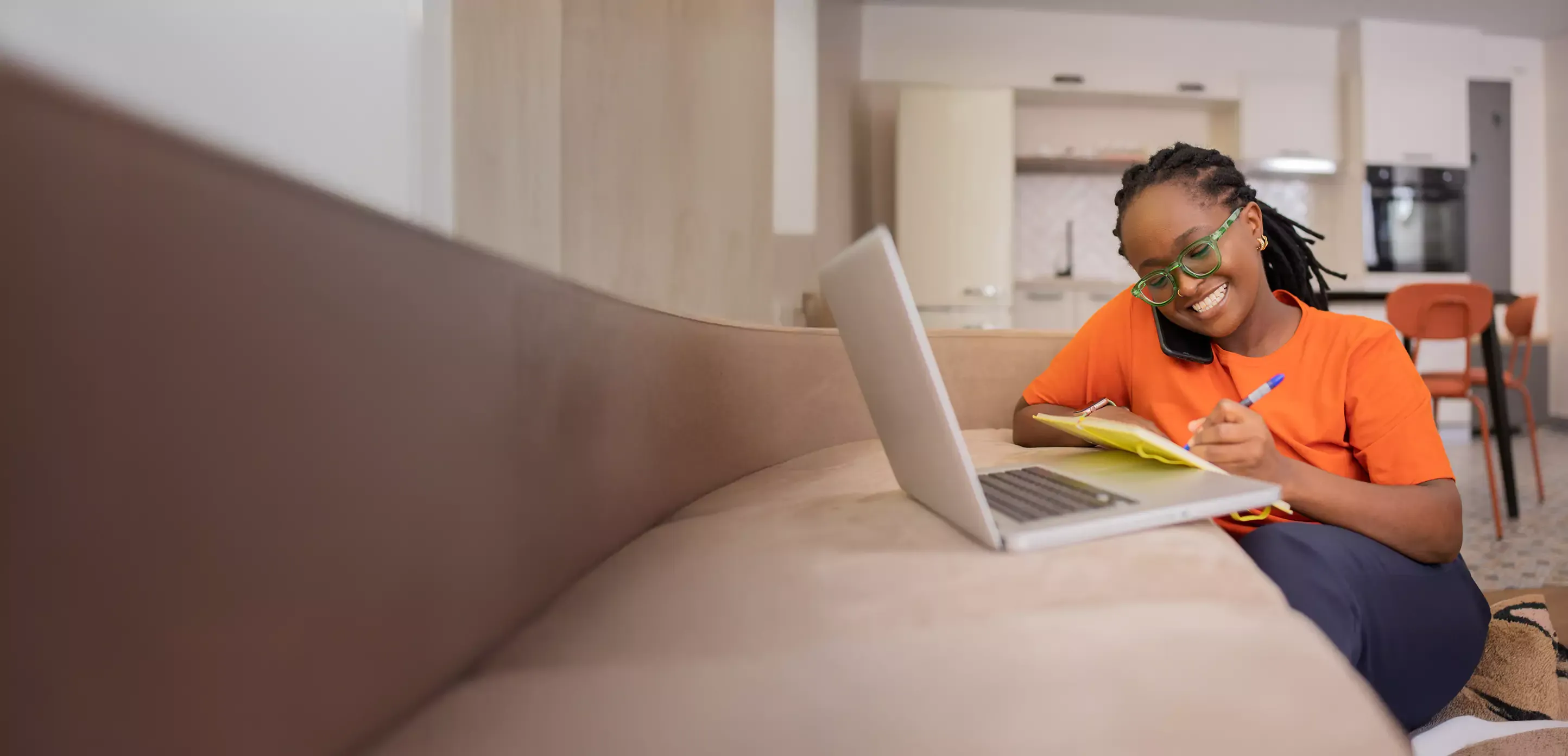 Happy woman uses laptop at home with fast, affordable internet.
