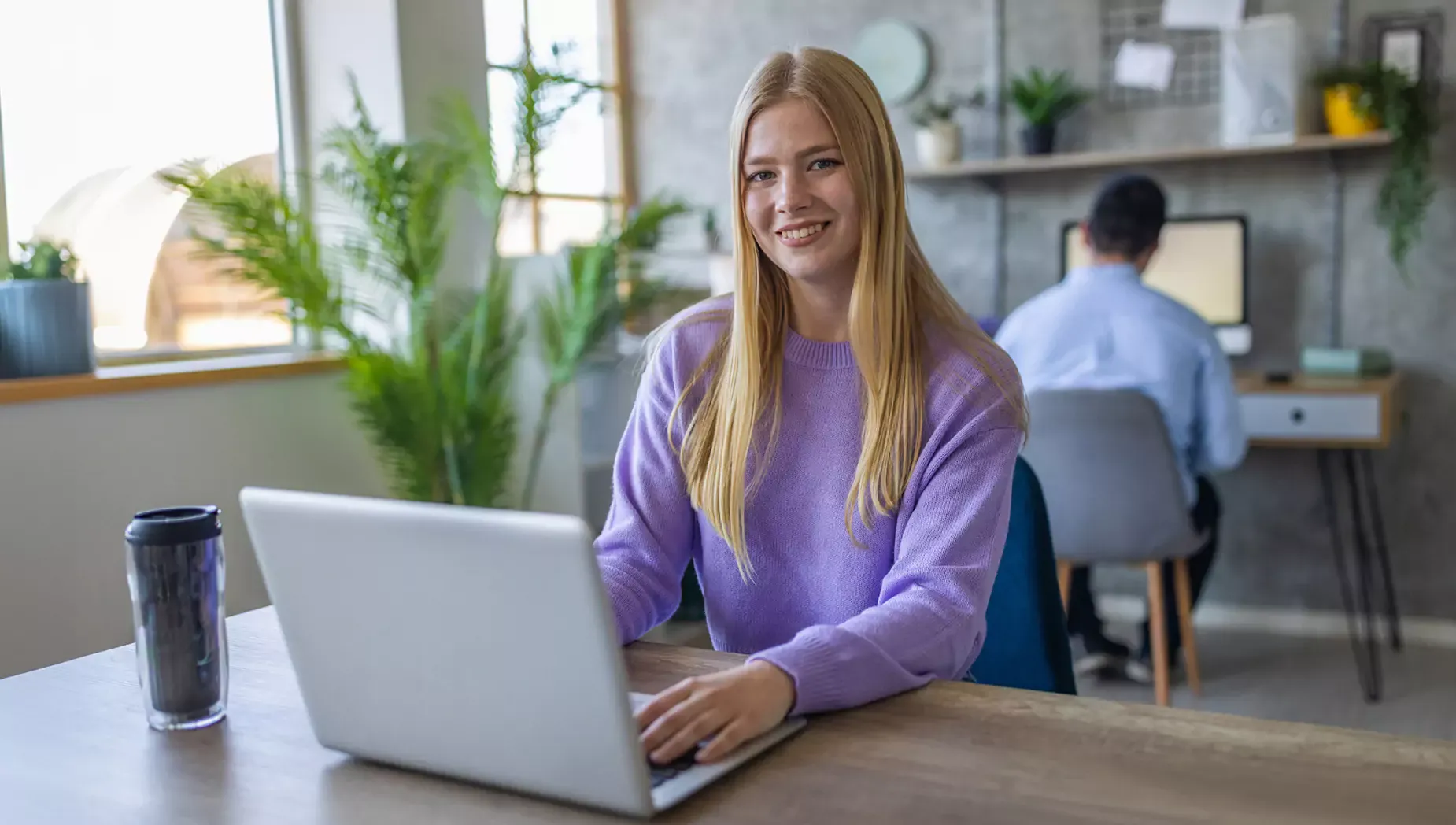 Woman uses laptop in workplace.