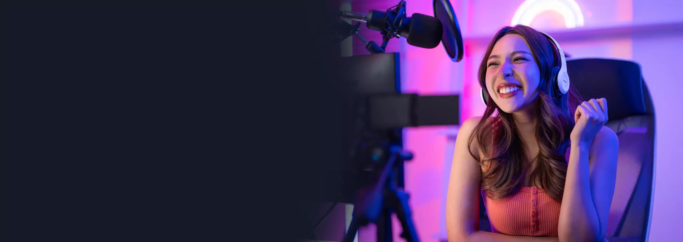 Woman smiles for the camera as she films herself at home for social media.