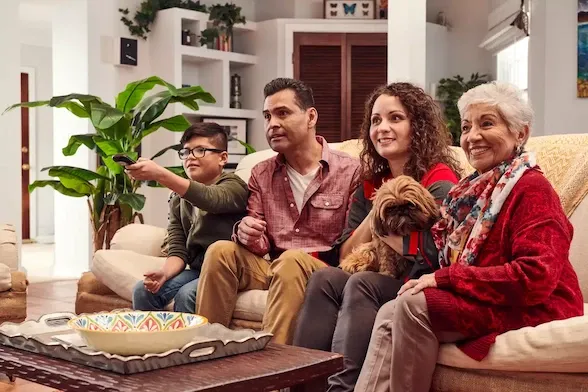 latino family watching tv