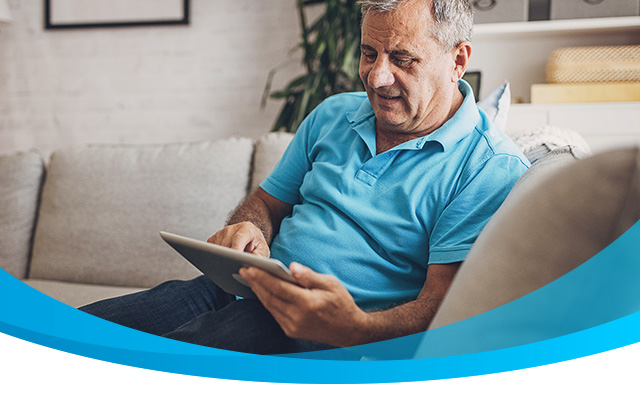 elderly man searches using a tablet