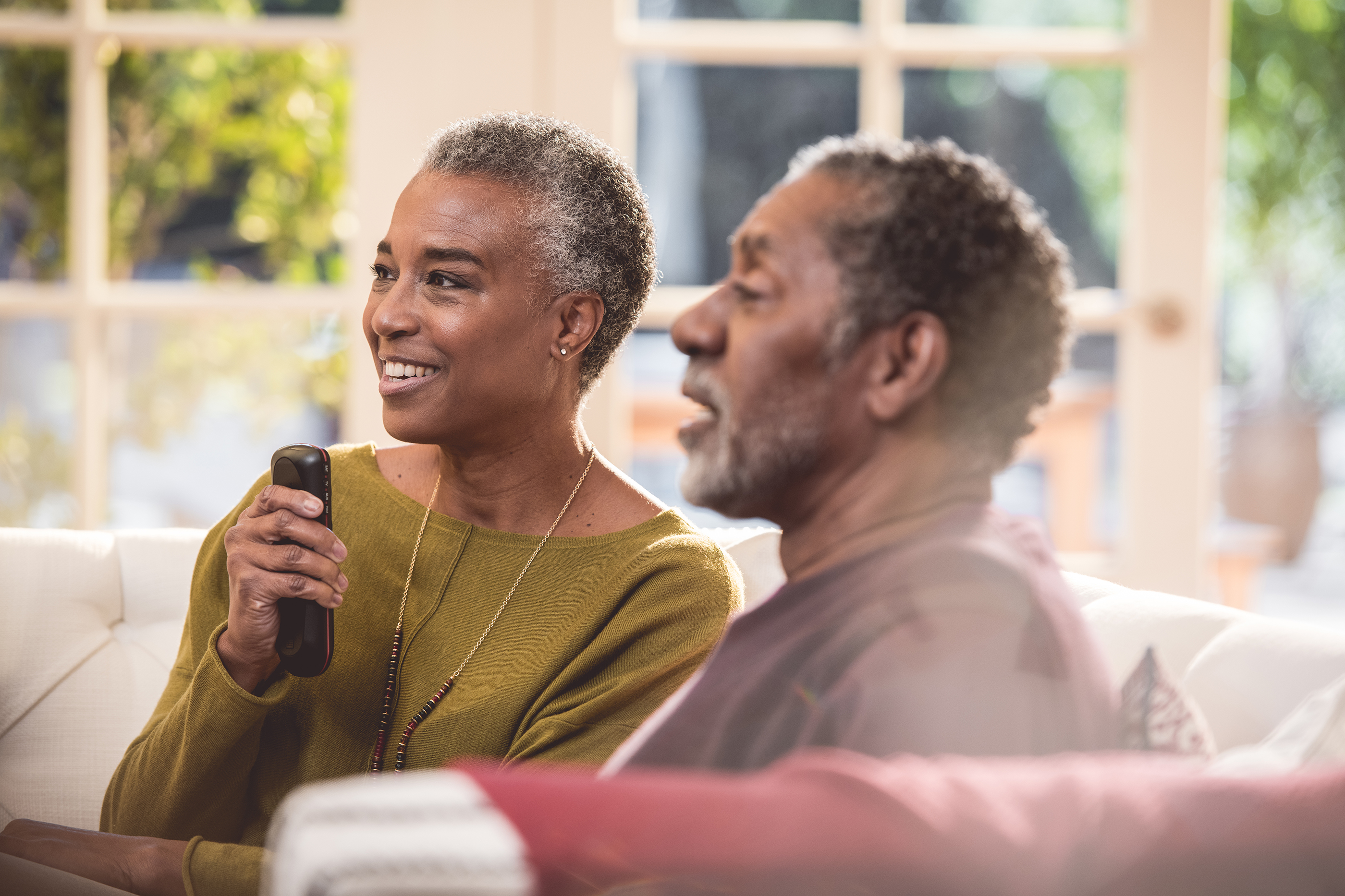 Elderly couple using DISH voice remote