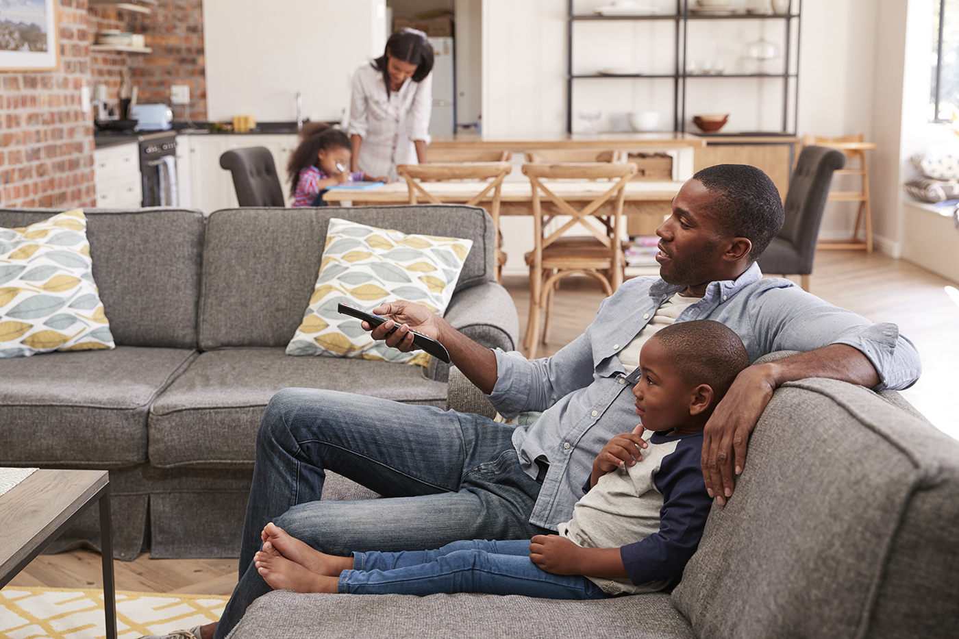 Father and son watching tv on the couch