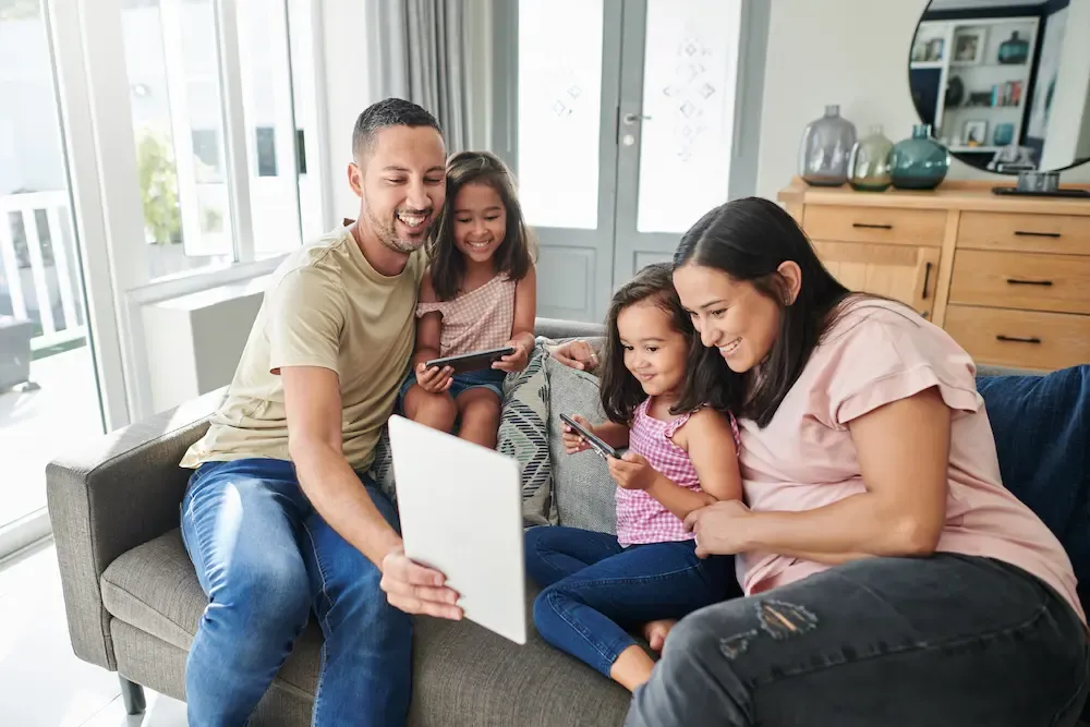 Young family using digital devices