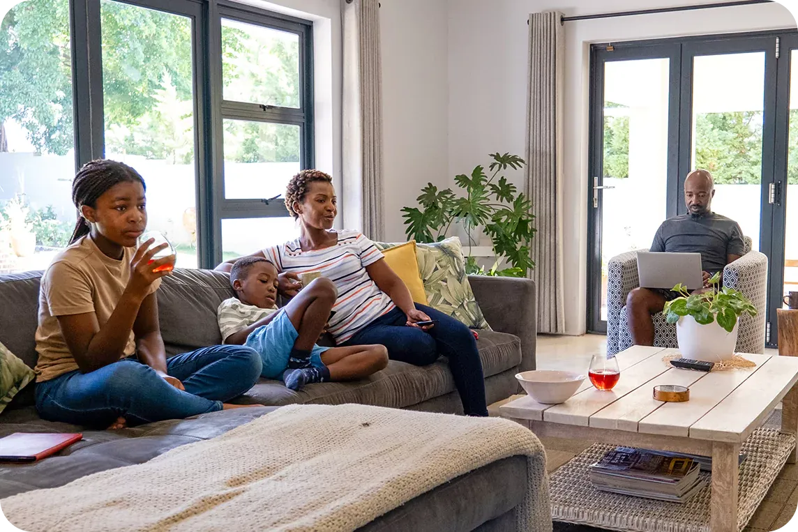 family watching tv and using internet devices