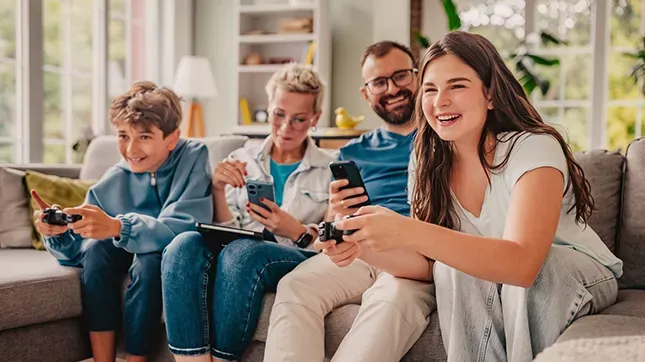 Happy family with fast fiber internet uses electronic devices at home
