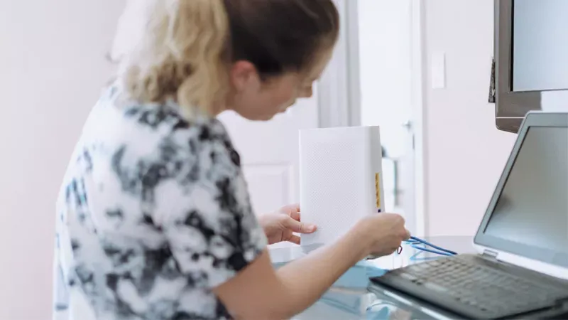 A woman checking her routers connection.