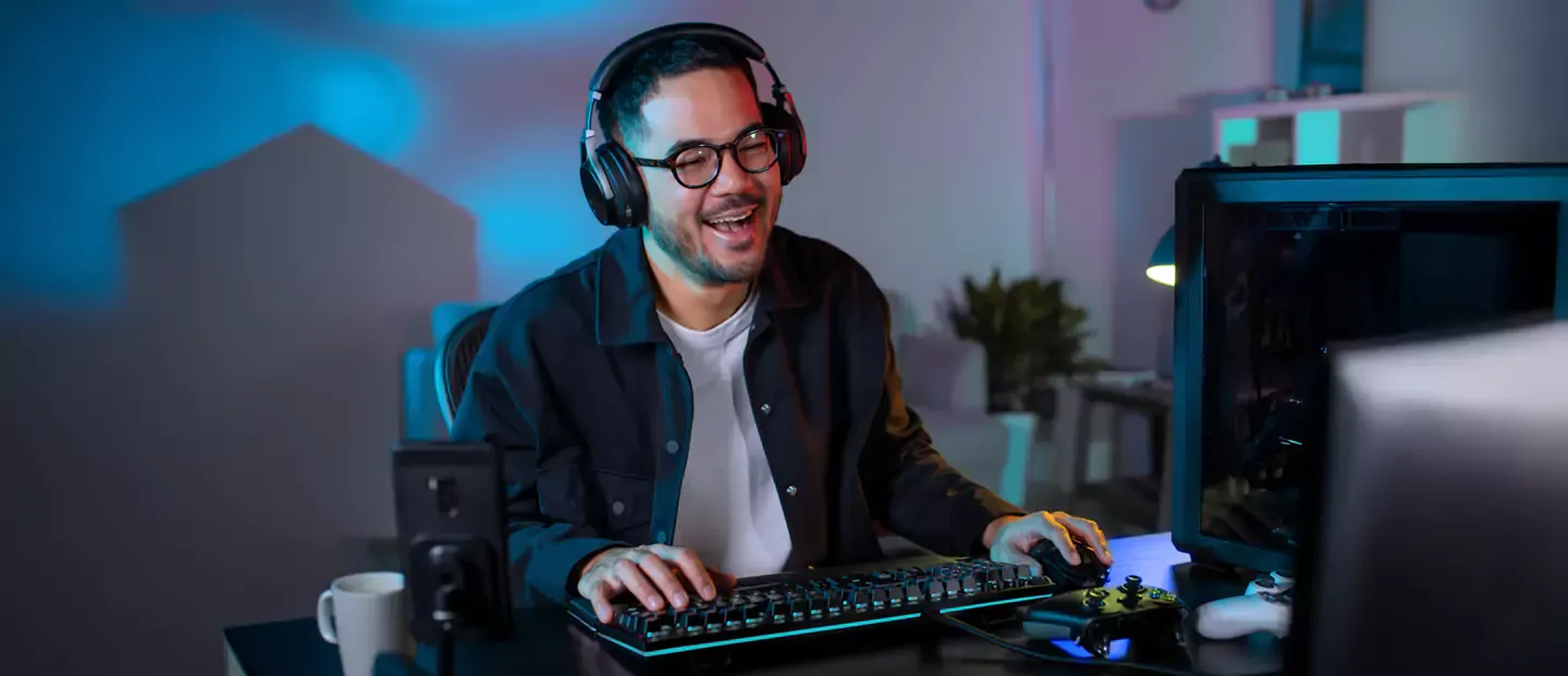 Man smiling and enjoying online gaming.