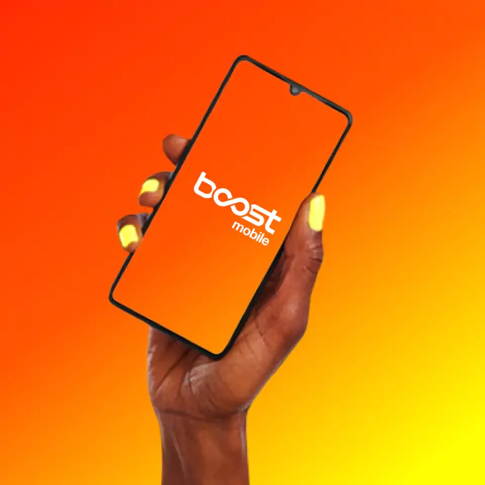 Hand holding a cellphone, with an orange and yellow background.