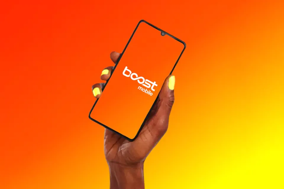 Hand holding a cellphone, with an orange and yellow background.