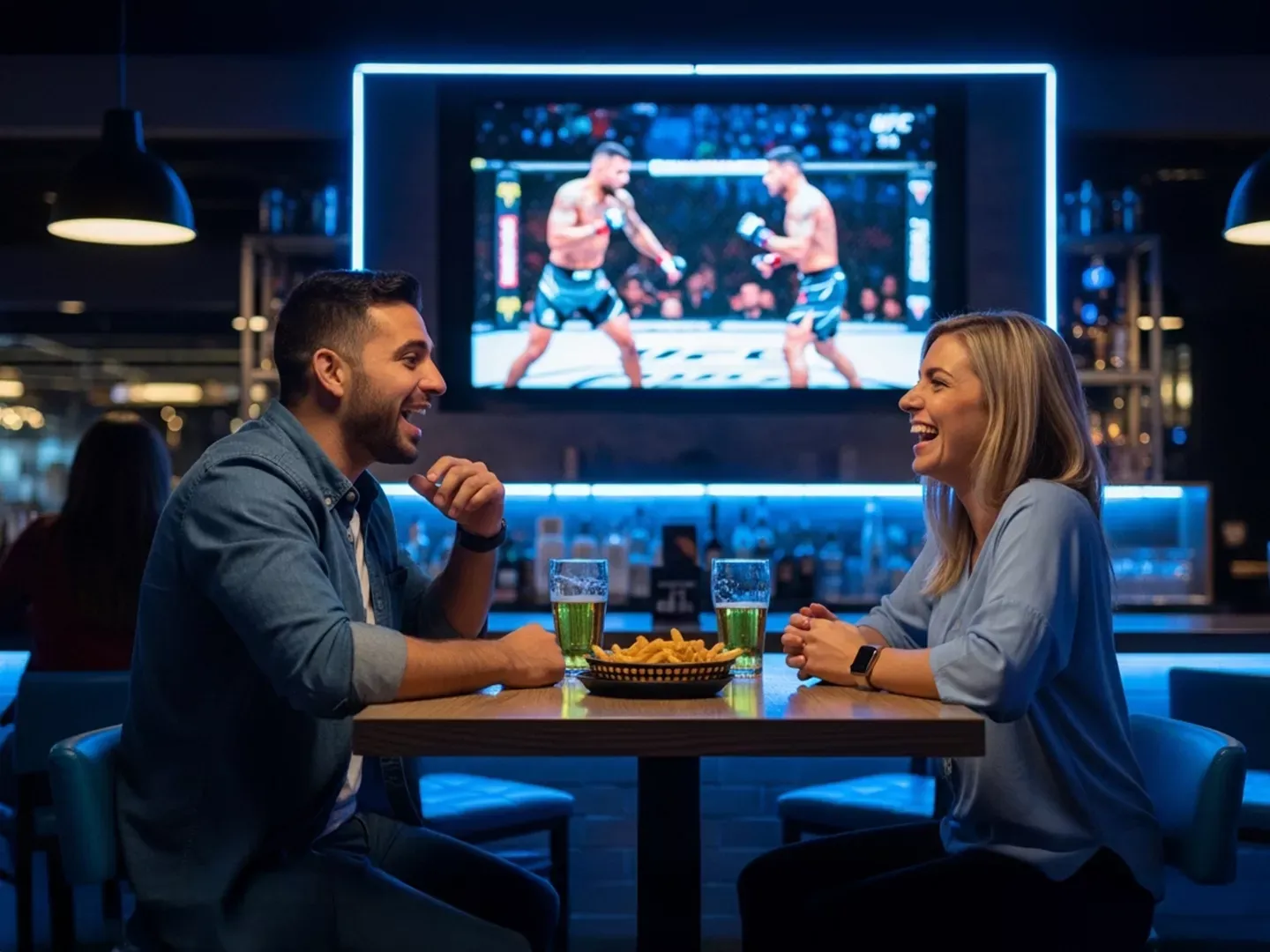 Happy couple talks as they watch UFC fight inside a bar