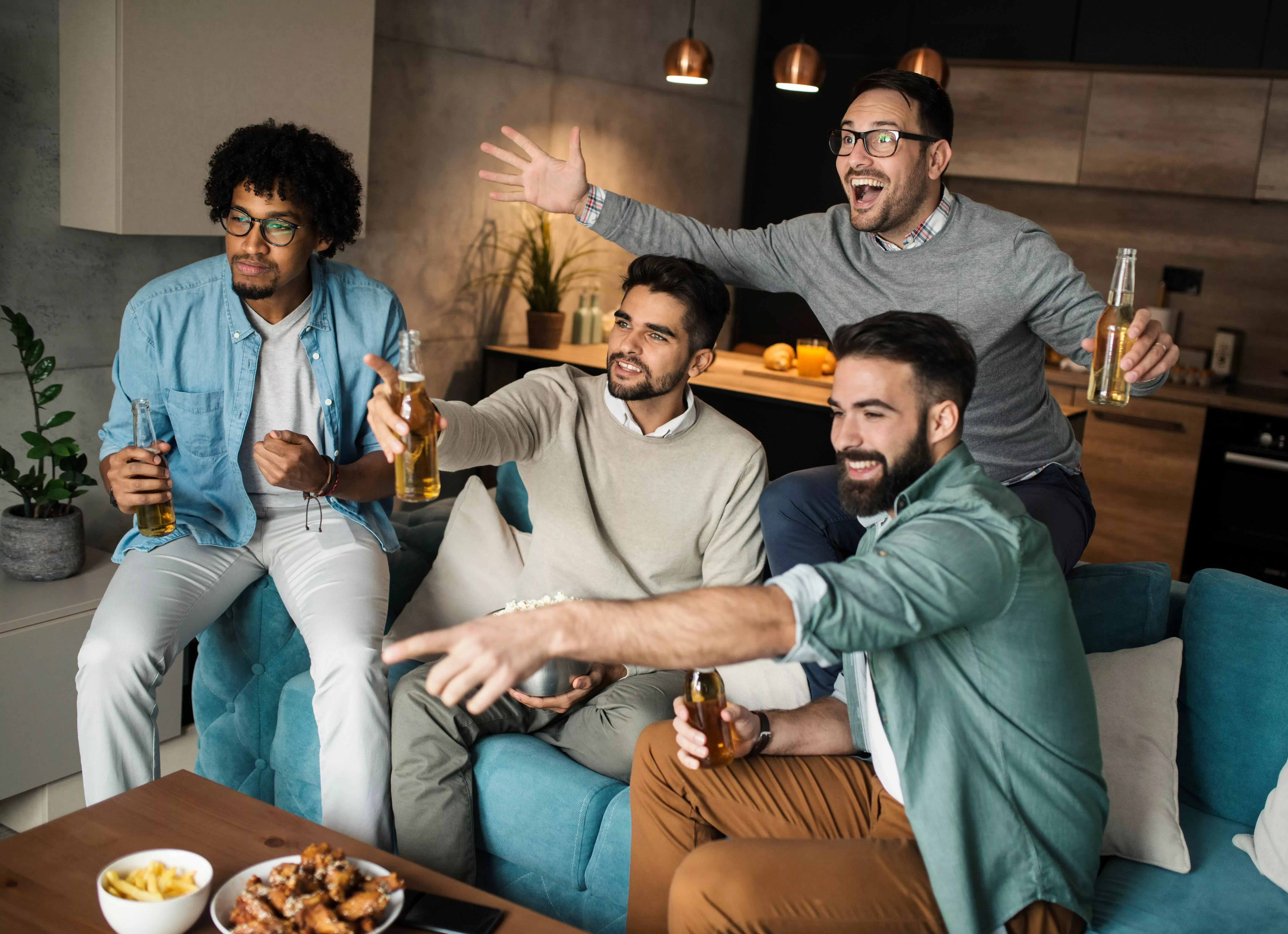 Happy friends watch sports at home